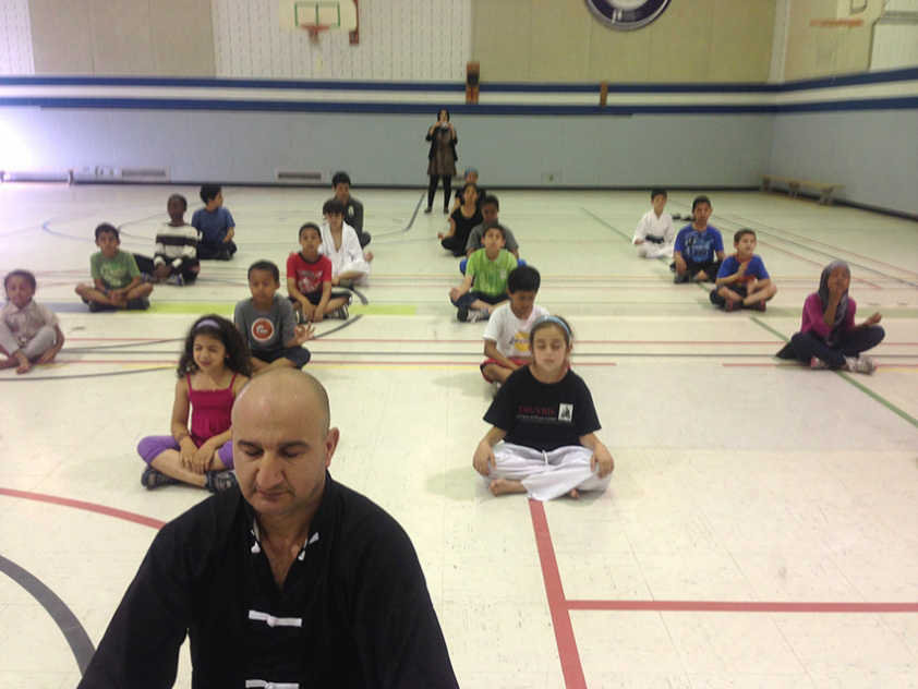 Martial Arts instructor Mohammed Al Nuiaimi leads students in quiet meditation.