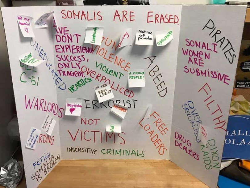 "Somalis are erased": The Somali Students Association at York University organized a vigil this week where a poster was on display highlighting negative words associated with Somali folks, vigil participants were given space to reclaim their narrative by writing positive affirmations beside the negative stereotypes.